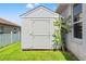 Exterior shot of backyard shed for extra storage next to cactus at 13627 Lightning Rod Ct, Hudson, FL 34669