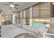 A sunroom with tile flooring with views to the backyard pool area and beyond the picket fence at 13627 Lightning Rod Ct, Hudson, FL 34669