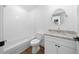 Bathroom features subway tile, granite countertop, and white vanity offering a clean, modern design at 14376 Earline Rd, Brooksville, FL 34614
