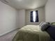 This bedroom is carpeted and includes a window at 1508 Figleaf Ln, Clearwater, FL 33756
