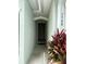 Charming entrance with elegant trim and a modern, solid door and clean plants at 1508 Figleaf Ln, Clearwater, FL 33756