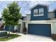 Well-maintained townhome with a blue garage door and a clean, paved driveway at 1508 Figleaf Ln, Clearwater, FL 33756