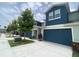 Charming townhouse with a well-manicured lawn and a blue garage door and clean driveway at 1508 Figleaf Ln, Clearwater, FL 33756