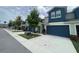 Inviting townhome featuring a blue garage door, clean driveway, and well-kept landscaping at 1508 Figleaf Ln, Clearwater, FL 33756