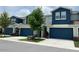 Beautiful townhome featuring a blue garage door, modern architecture and a manicured lawn at 1508 Figleaf Ln, Clearwater, FL 33756