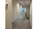 Bright hallway with neutral walls, recessed lighting, and gray carpeting at 1508 Figleaf Ln, Clearwater, FL 33756