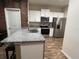 Modern kitchen featuring stainless steel appliances, granite countertops and white cabinetry at 1508 Figleaf Ln, Clearwater, FL 33756