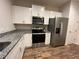 Spacious kitchen featuring granite countertops, stainless appliances and ample storage at 1508 Figleaf Ln, Clearwater, FL 33756