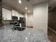Bright kitchen with white cabinets, stainless steel appliances, granite counters and view of entryway at 1508 Figleaf Ln, Clearwater, FL 33756