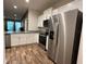 Stylish kitchen with stainless steel appliances, granite counters, and wood-look flooring at 1508 Figleaf Ln, Clearwater, FL 33756