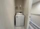 Bright laundry room with full-sized washer and shelf at 1508 Figleaf Ln, Clearwater, FL 33756