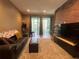 Comfortable living room with brick accent wall, stylish furniture, and access to screened patio at 1508 Figleaf Ln, Clearwater, FL 33756