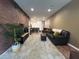 Spacious living room boasts modern design with exposed brick wall and plush shag rug at 1508 Figleaf Ln, Clearwater, FL 33756