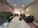 Living room featuring a large exposed brick wall, shag rug and modern furnishings at 1508 Figleaf Ln, Clearwater, FL 33756