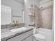 Bathroom featuring granite countertops, updated vanity and fixtures, and shower over bath at 15241 Caravan Ave, Odessa, FL 33556