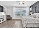 A beautifully styled bedroom with a large wall of windows to let in natural light and an accent chair at 15241 Caravan Ave, Odessa, FL 33556