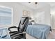Bedroom with a blue bed and work desk, window with blinds and double door closet at 15241 Caravan Ave, Odessa, FL 33556