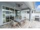 Stylish covered patio with a ceiling fan and outdoor dining area, perfect for enjoying outdoor meals and gatherings at 15241 Caravan Ave, Odessa, FL 33556