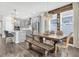 Open floor plan with a dining room next to the kitchen featuring modern appliances and hardwood flooring at 15241 Caravan Ave, Odessa, FL 33556