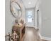 Inviting entryway with hardwood floors, mirror, console table, and natural light at 15241 Caravan Ave, Odessa, FL 33556