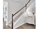Traditional stairway with wood handrail, gray carpet and white trim, plus a white dresser with a lamp at 15241 Caravan Ave, Odessa, FL 33556