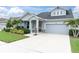 Charming one-story home with a manicured lawn, a driveway, and tasteful landscaping, showcasing curb appeal at 15241 Caravan Ave, Odessa, FL 33556