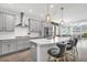 Bright, modern kitchen features gray cabinets, stainless steel appliances, and a white quartz countertop island with seating at 15241 Caravan Ave, Odessa, FL 33556