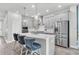 Modern kitchen featuring stainless steel appliances, a quartz countertop island, and pendant lighting at 15241 Caravan Ave, Odessa, FL 33556
