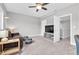 Comfortable living room featuring a leather couch, contemporary ceiling fan, and large tv at 15241 Caravan Ave, Odessa, FL 33556