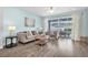 Comfortable living room with sliding glass doors to the backyard and hardwood floors at 15241 Caravan Ave, Odessa, FL 33556
