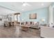 Open-concept living area with hardwood floors, comfortable seating, and ample natural light at 15241 Caravan Ave, Odessa, FL 33556