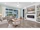 Bright living room featuring modern furnishings, a fireplace, built-in shelves, and sliding glass doors at 15241 Caravan Ave, Odessa, FL 33556