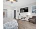 Spacious main bedroom featuring a TV, accent chair, and large windows for natural light at 15241 Caravan Ave, Odessa, FL 33556