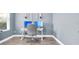 Home office showcasing desk, chair, dual monitors, wood flooring, and natural light from nearby window at 15241 Caravan Ave, Odessa, FL 33556