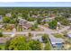 Aerial view of the neighborhood, with lush tree cover, water in the distance, and single-Gathering homes at 16018 Adobe Dr, Hudson, FL 34667