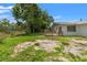 Backyard showing the home's yard space and wood deck at 16018 Adobe Dr, Hudson, FL 34667