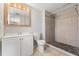 Bathroom features a walk-in shower with stone flooring and decorative tile accents at 16018 Adobe Dr, Hudson, FL 34667