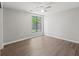 Bedroom with a single window, hardwood flooring and neutral color walls at 16018 Adobe Dr, Hudson, FL 34667