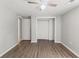 Bedroom features hardwood flooring and neutral paint at 16018 Adobe Dr, Hudson, FL 34667