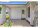 Covered entrance features a white door, mosaic tile, and stone accents at 16018 Adobe Dr, Hudson, FL 34667