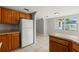 Kitchen with tile flooring and wood cabinets adjacent to the dining area at 16018 Adobe Dr, Hudson, FL 34667