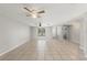 Large open living room featuring tile flooring, a ceiling fan, and a view of the backyard at 16018 Adobe Dr, Hudson, FL 34667