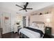 Cozy bedroom featuring modern decor, ceiling fan, and a well-lit vanity area at 1602 Beachway Ln, Odessa, FL 33556