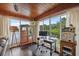 Bright home office with wood ceiling, large windows overlooking lake and vintage decor elements at 1602 Beachway Ln, Odessa, FL 33556