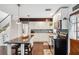 Open kitchen showcasing an island with bar stools, white cabinetry, and modern appliances for a functional cooking space at 1602 Beachway Ln, Odessa, FL 33556