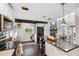Bright and modern kitchen showcasing an island with seating, dark countertops, and easy access to the dining area at 1602 Beachway Ln, Odessa, FL 33556