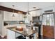 Well-equipped kitchen with white cabinets, stainless steel appliances, a subway tile backsplash, and wooden accents at 1602 Beachway Ln, Odessa, FL 33556