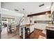 Modern kitchen featuring an island with bar stool seating, granite countertops, and sleek, updated appliances at 1602 Beachway Ln, Odessa, FL 33556