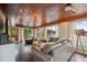 Spacious living room with wood accents, floor to ceiling windows and stunning lake view at 1602 Beachway Ln, Odessa, FL 33556