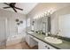 Bright bathroom with double sinks, large mirrors, and a separate tub and shower at 1623 Crossvine Ct, New Port Richey, FL 34655